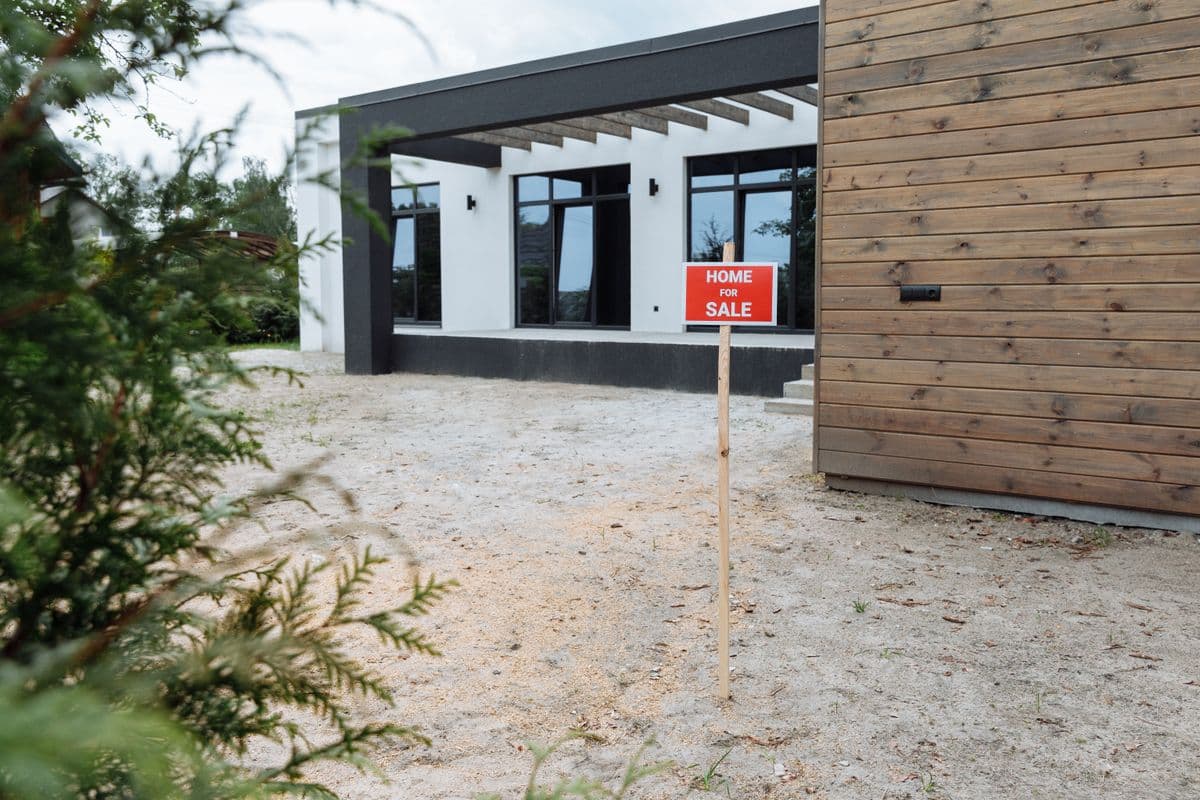 A for-sale sign in a front yard